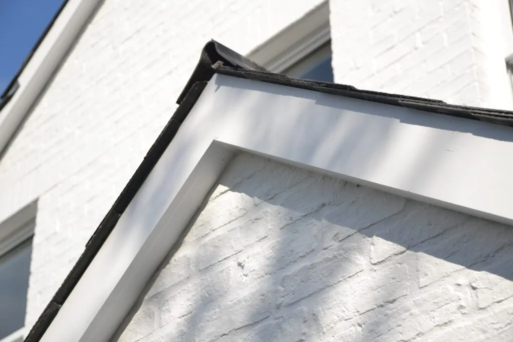 Freshly painted roofline and white render on a Surrey house exterior
