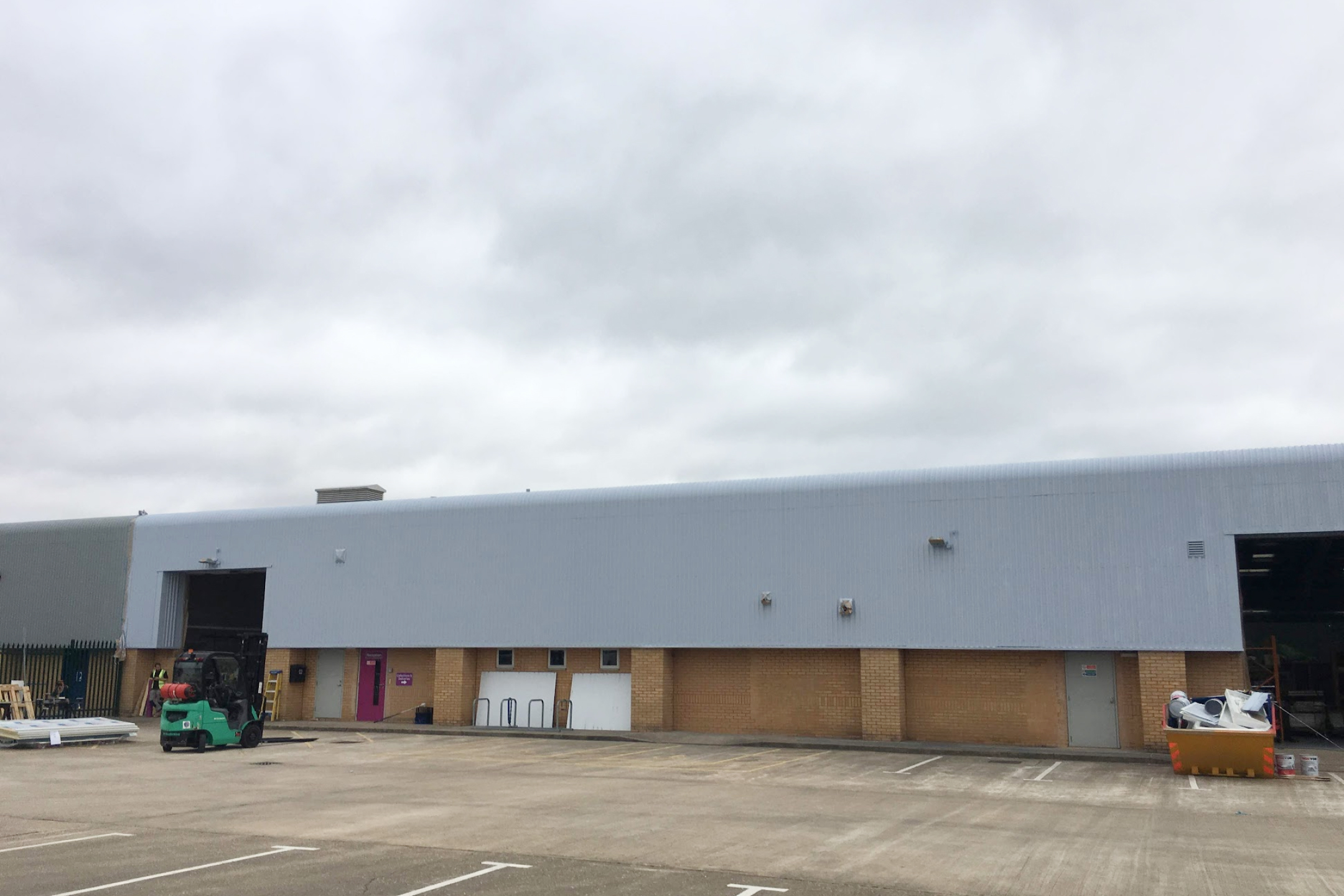 Paint spraying of warehouse unit cladding using SMP paint