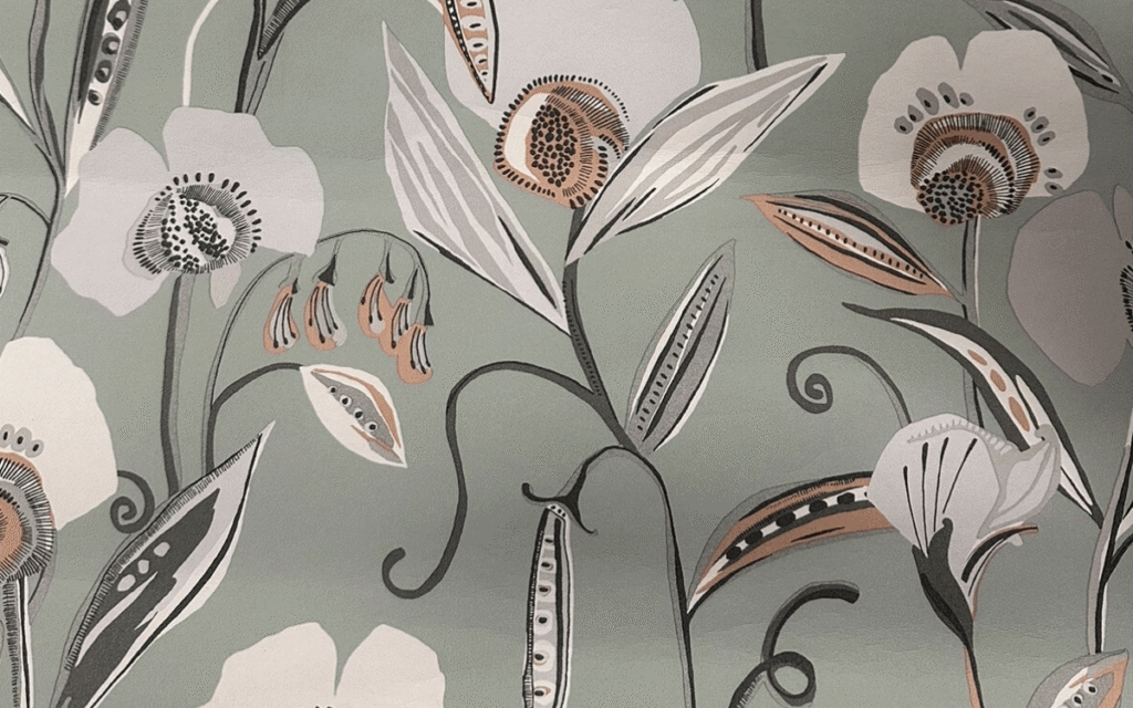 Floral patterned wallpaper featuring stylized white, beige, and orange flowers with green leaves on a muted green background—perfect for embracing the latest wallpaper trends.